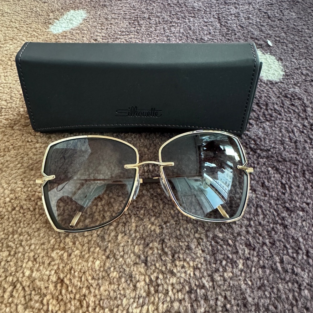 Silhouette New York Sky Sunglasses 
Black lenses with gold metal wiring